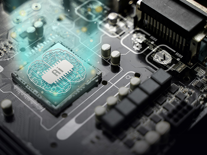 Stock photo of computer board with AI stamped on the chip