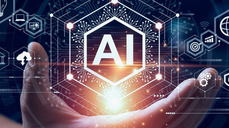 Hand holding digital art with the letters AI