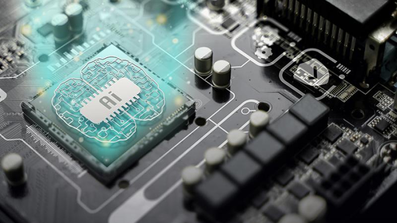 Stock photo of computer board with AI stamped on the chip